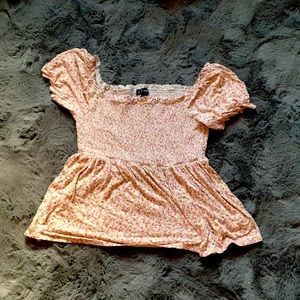 This is a puffed sleeved tee with a floral design